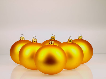 Golden Christmas balls. Shiny and watched closely. On a light background.の写真素材