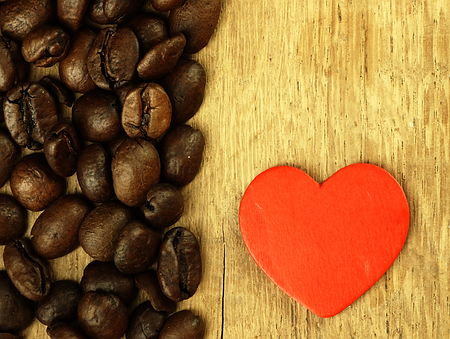 Heart and Coffee beans on a wooden surface. の写真素材