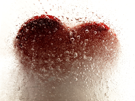 Ice cube with a heart in the middle and visible air bubbles.の写真素材
