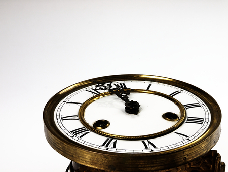 Mechanism of old clock. Clock face and hands showing five minutes to midnight.の写真素材