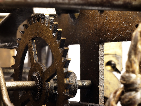 Old clock seen from the side of its mechanism together with the sprockets.の写真素材