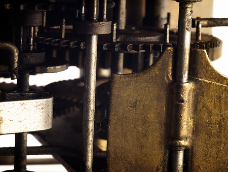 Old clock seen from the side of its mechanism together with the sprockets.の写真素材