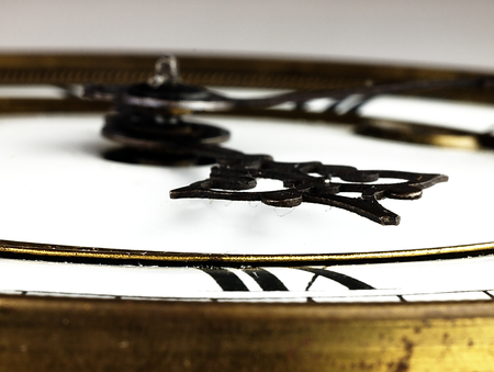 Mechanism of old clock. Clock face and hands showing five minutes to midnight.の写真素材