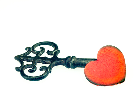 Historical key of the clock and wooden, red heart.の写真素材