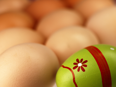 One colored Easter egg and a few ordinary eggs.