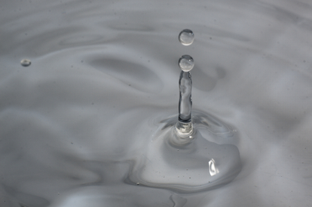 Splash of water drops falling from the top.の写真素材