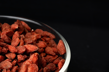 Goji berries in a bowl on the table.