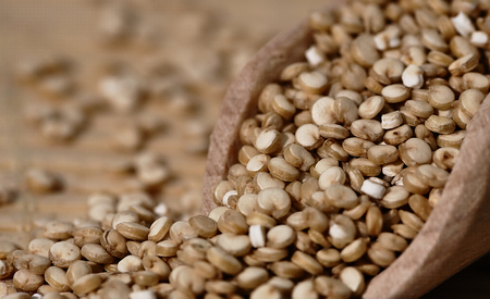 Grain quinoa scattered on the wooden surface.の写真素材
