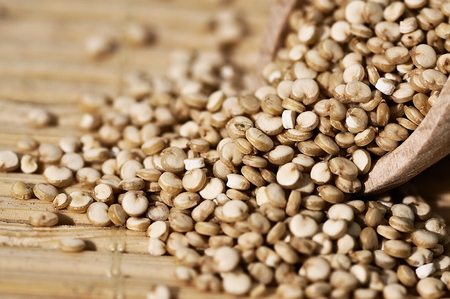 Grain quinoa scattered on the wooden surface.の写真素材