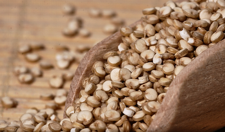 Grain quinoa scattered on the wooden surface.の写真素材