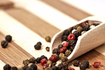 Dried colorful pepper on a wooden, two-tone surface.の写真素材