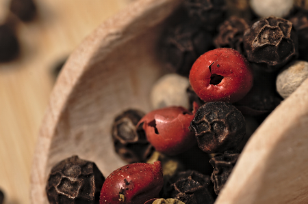 Dried colorful pepper on a wooden, two-tone surface.の写真素材