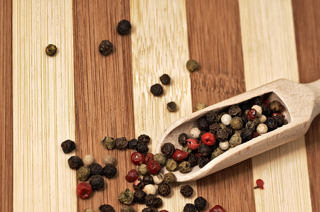 Dried colorful pepper on a wooden, two-tone surface.