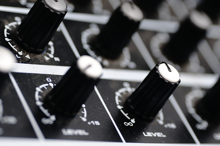 Sound mixer in the studio. Colored switches, jacks and knobs.
