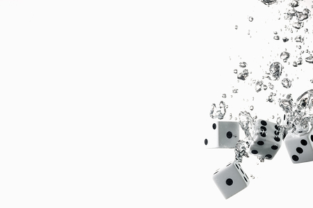 Dice game under the water. Visible splash and air bubbles.の写真素材