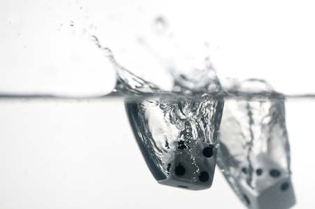 Dice game under the water. Visible splash and air bubbles.の写真素材
