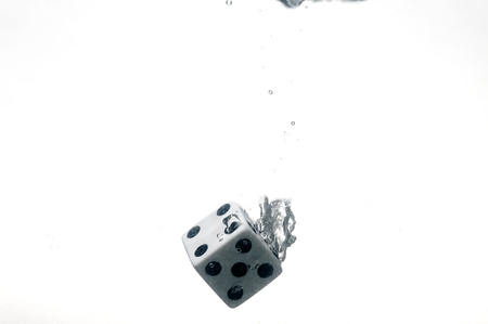 Dice game under the water. Visible splash and air bubbles.の写真素材