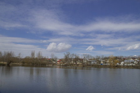 Pond with overhanging clouds against a blue skyの写真素材