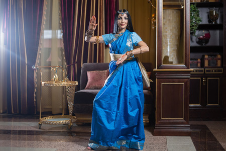 Caucasian woman is dancing in traditional indian dressの写真素材
