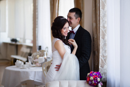 The groom kisses the bride in her headの写真素材