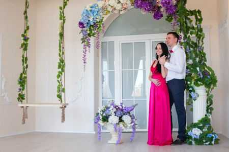 Couple near the swings and arches of flowersの写真素材