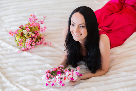Lovely girl in pink dress smilingの写真素材