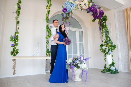 Couple near the swings and arches of flowersの写真素材