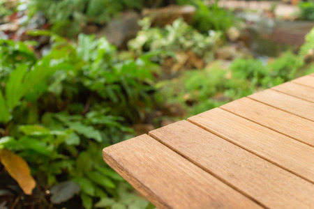 Empty top wooden table and garden background. For product displayの写真素材