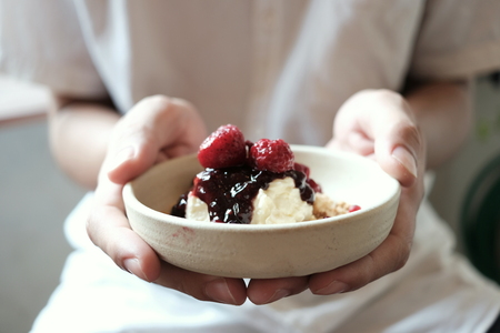 Holding a strawberry cheese pieの写真素材