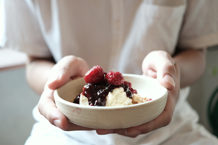 Holding a strawberry cheese pie