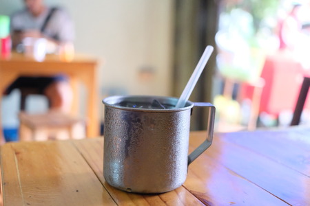 Stainless steel cup on wooden table.の写真素材