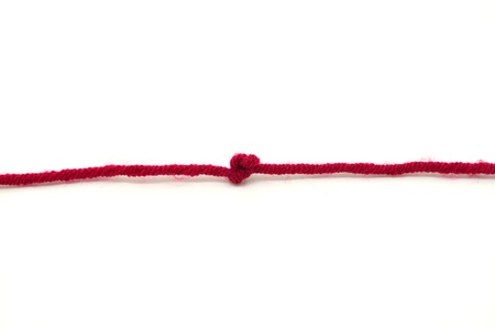 Red rope with knot, isolated on white backgroundの写真素材
