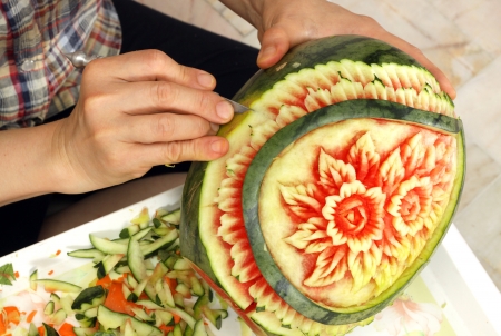 Woman s hands carved watermelon show stepの写真素材