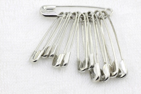 Bunch of safety pins on fabric
