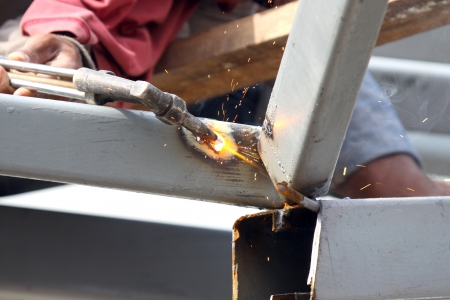 Sparks during cutting of metal by gas welding in site