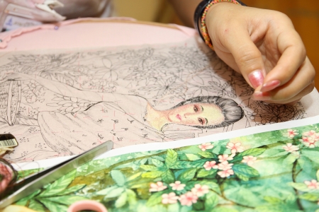 Woman hand embroiders with a needle and a thread のeditorial素材