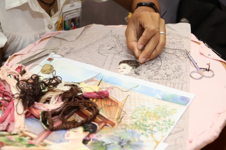 Woman hand embroiders with a needle and a thread のeditorial素材