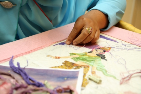 Woman hand embroiders with a needle and a thread のeditorial素材
