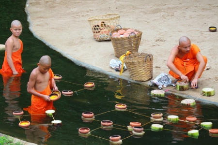 CHIANG MAI, THAILAND - November 28: 	Loy Kratong Festival, Buddhist monk fire candles to the Buddha on Nov 28, 2012 in Phan Tao Temple, Chiangmai, Thailand. のeditorial素材