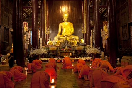 CHIANG MAI, THAILAND - November 28: 	Loy Kratong Festival, Buddhist monk fire candles to the Buddha on Nov 28, 2012 in Phan Tao Temple, Chiangmai, Thailand. のeditorial素材