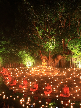 CHIANG MAI, THAILAND - November 28: 	Loy Kratong Festival, Buddhist monk fire candles to the Buddha on Nov 28, 2012 in Phan Tao Temple, Chiangmai, Thailand. のeditorial素材