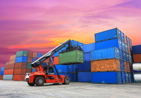 forklift handling the container box at dockyard with beautiful sky