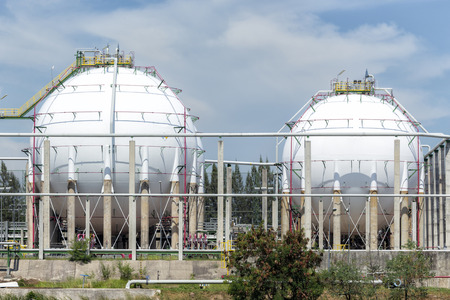 White large storage tanks under a blue sky. Gasoline, oil, chemical or other storage at factory side.のeditorial素材