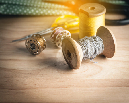 Sewing tools and sewing kit on wooden textured backgroundの写真素材