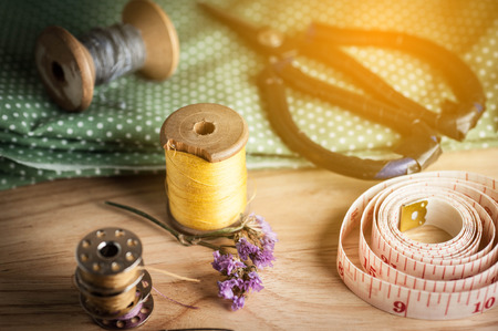 Sewing tools and sewing kit on wooden textured backgroundの写真素材
