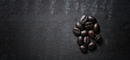 Coffee bean on black stone background