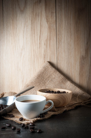 Coffee cup with coffee bean on black stone backgroundの写真素材