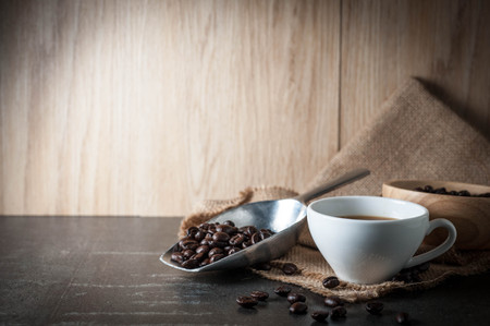 Coffee cup with coffee bean on black stone backgroundの写真素材