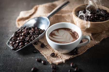 Coffee cup with coffee bean on black stone backgroundの写真素材