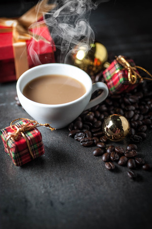 Coffee cup and christmas toys with pine brench on black stone background .の写真素材